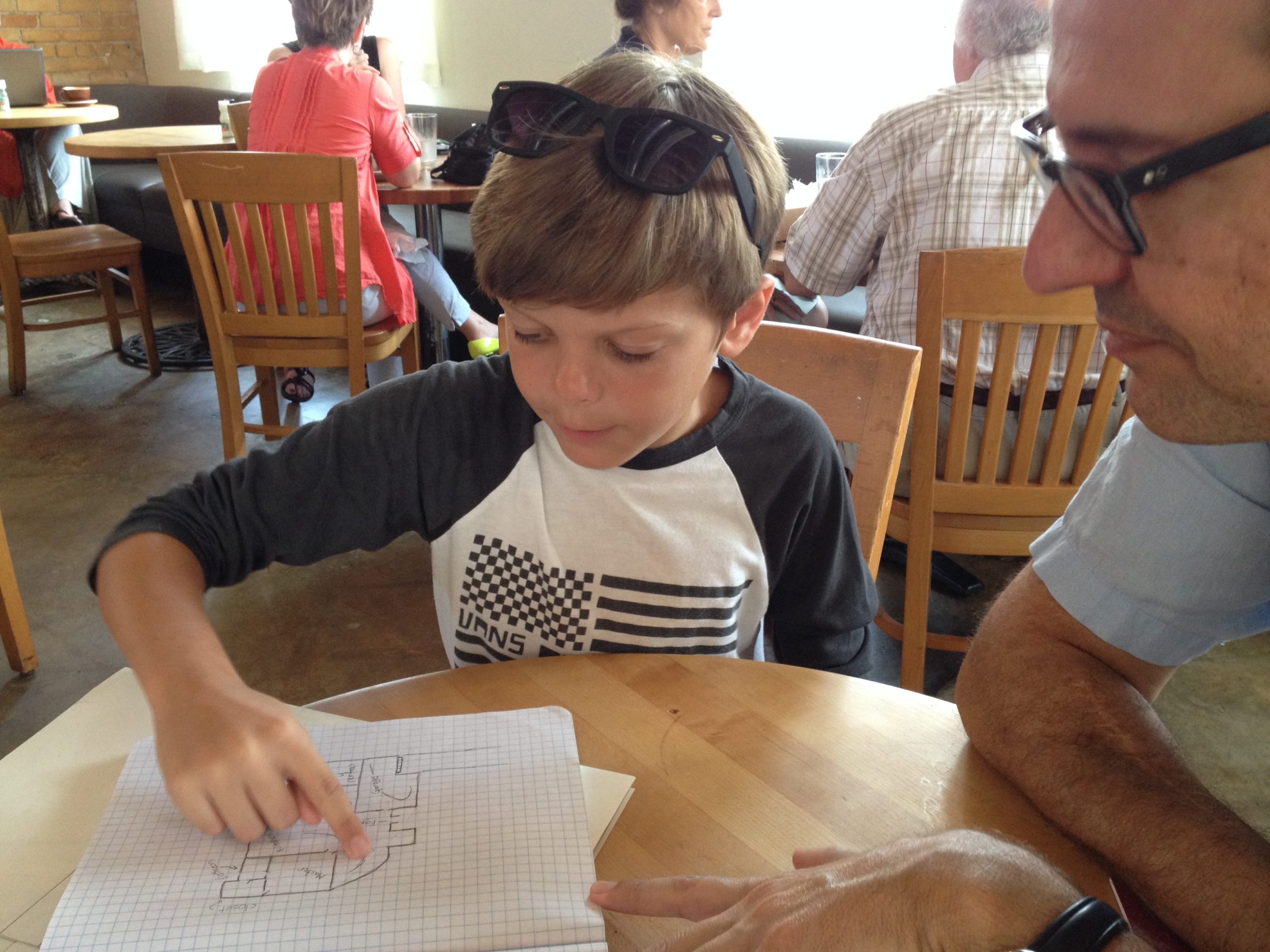 Carter showing Charles his sketchbook of floor plans!